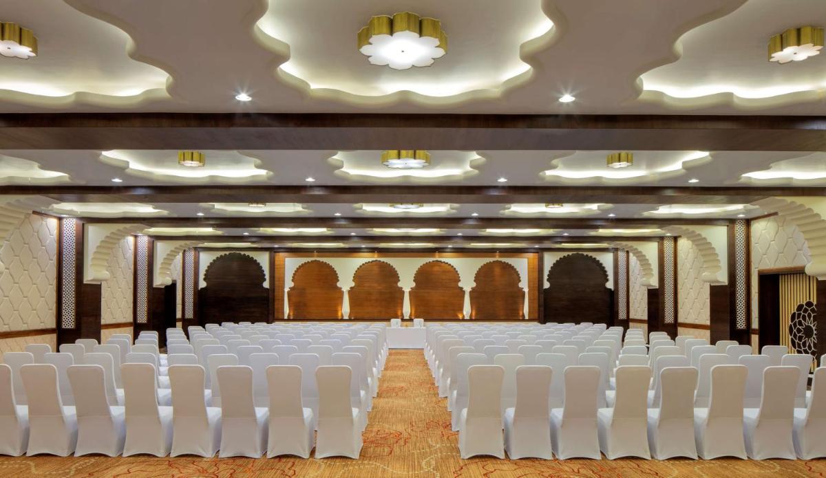an empty hall with white chairs in a room at Radisson Jodhpur in Jodhpur
