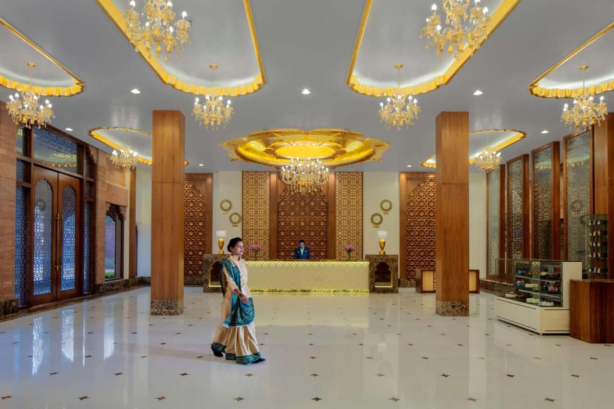 a woman standing in the middle of a lobby at Radisson Jodhpur in Jodhpur