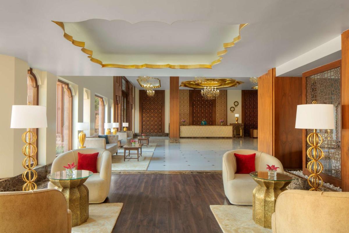a lobby with chairs and tables in a building at Radisson Jodhpur in Jodhpur