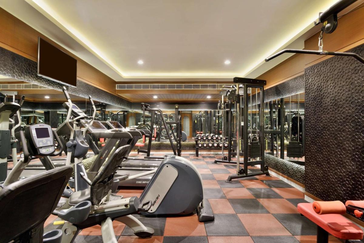 a gym with treadmills and elliptical machines at Radisson Jodhpur in Jodhpur