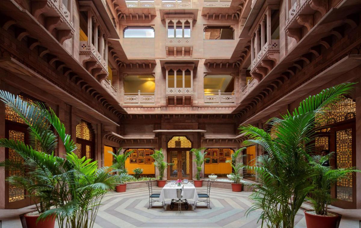 a large lobby with palm trees in a building at Radisson Jodhpur in Jodhpur