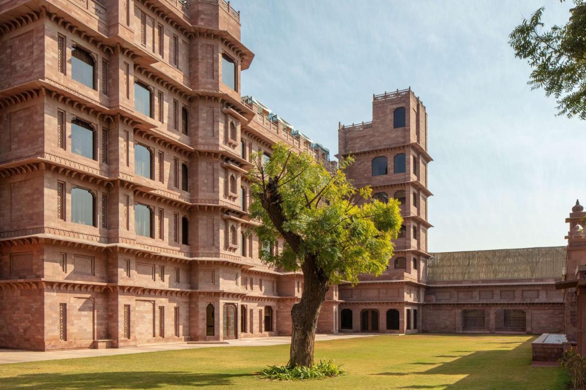 a building with a tree in front of it at Radisson Jodhpur in Jodhpur