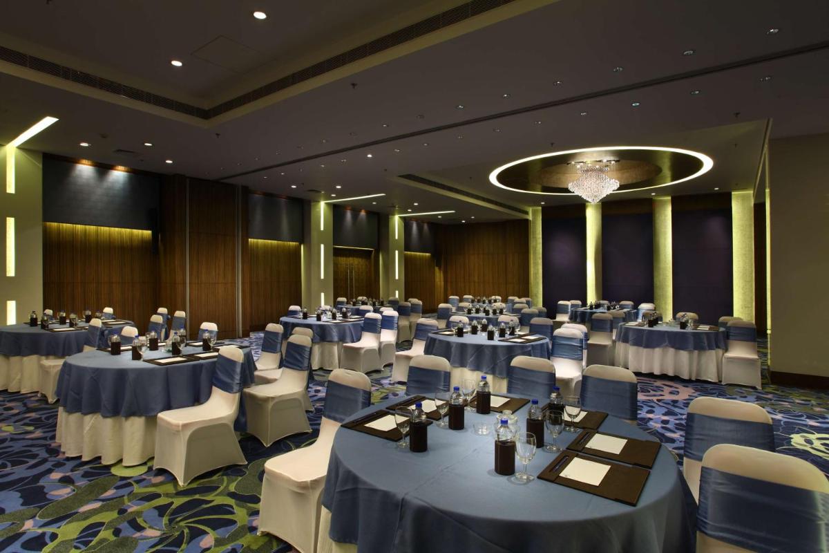 a banquet hall with tables and chairs in a room at Park Plaza Shahdara in New Delhi a banquet hall with tables and chairs in a room at Park Plaza Shahdara in New Delhi