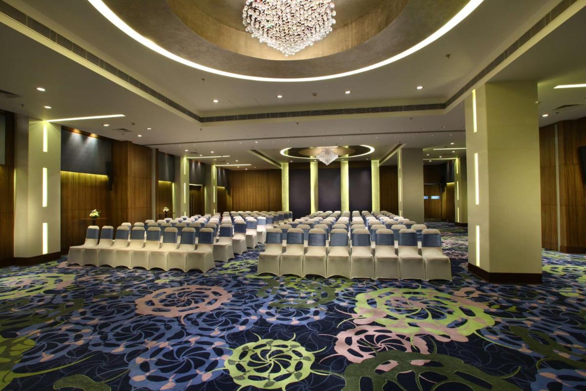a banquet hall with white chairs and a chandelier at Park Plaza Shahdara in New Delhi +48 photos a banquet hall with white chairs and a chandelier at Park Plaza Shahdara in New Delhi +48 photos