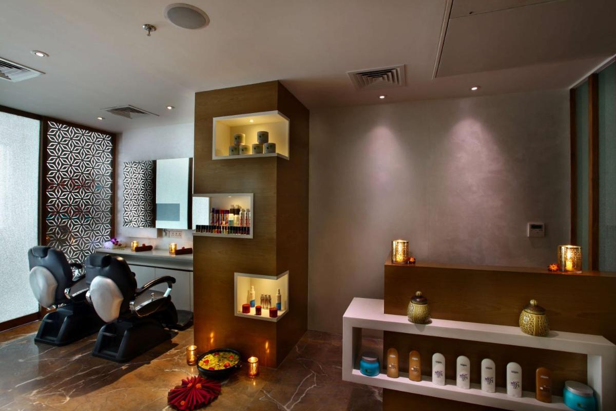 a salon with a barber chair and a barber shop at Park Plaza Shahdara in New Delhi a salon with a barber chair and a barber shop at Park Plaza Shahdara in New Delhi