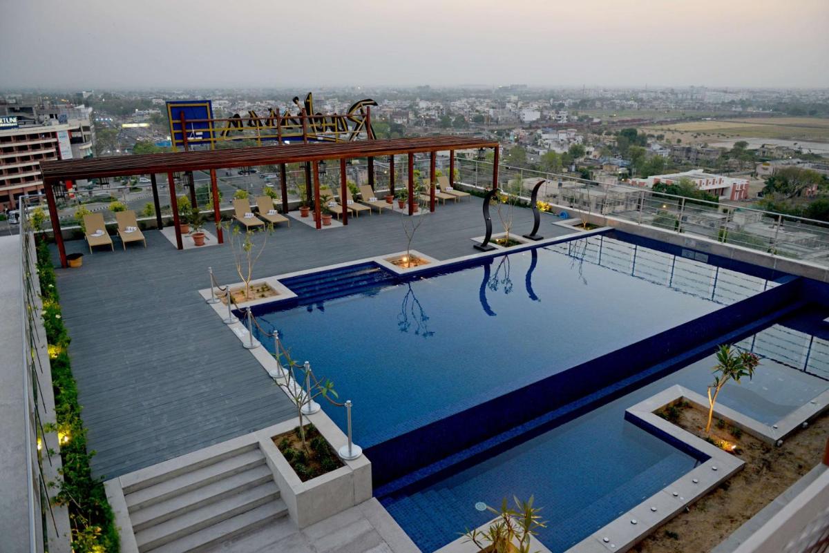 a large swimming pool on top of a building at Radisson Blu Jaipur in Jaipur