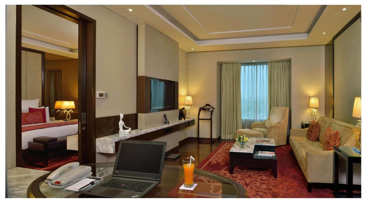 a hotel room with a laptop computer on a table at Radisson Blu Jaipur in Jaipur
