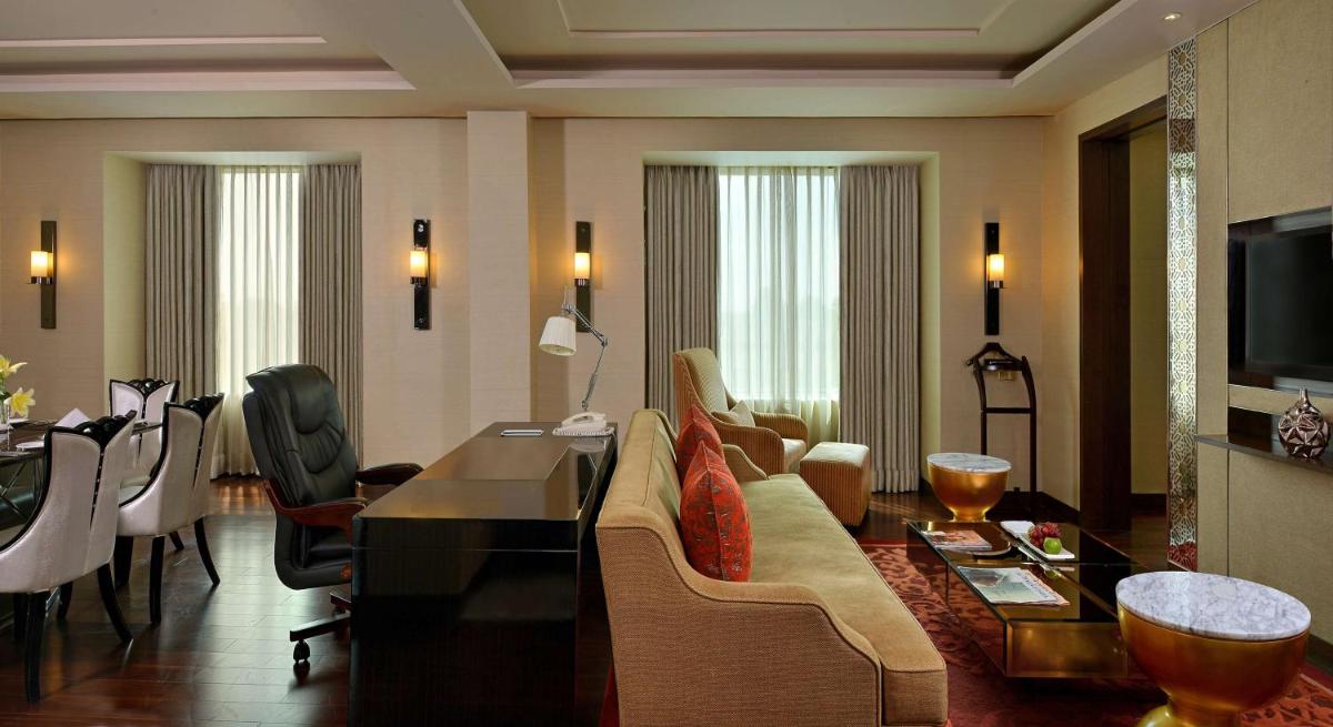 a living room with a couch and a table at Radisson Blu Jaipur in Jaipur