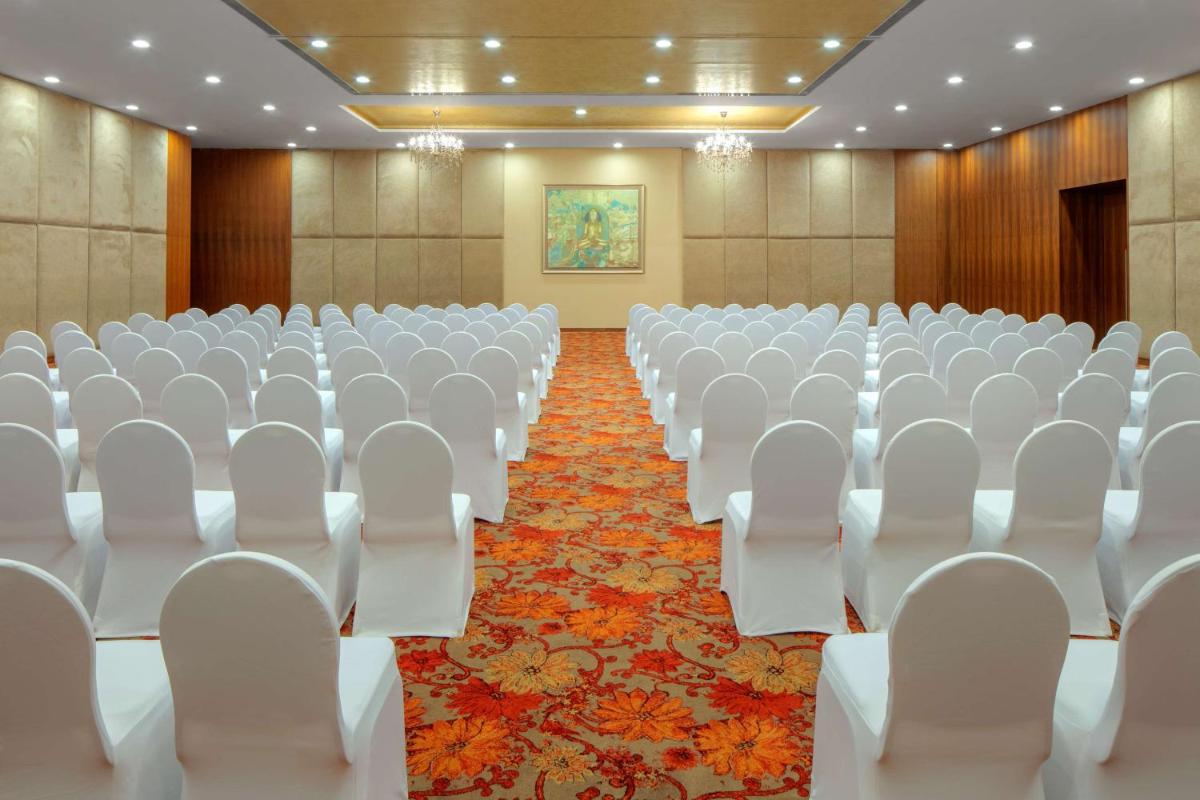 an empty conference room with white chairs and tables at Radisson Blu Plaza Hotel Hyderabad Banjara Hills in Hyderabad an empty conference room with white chairs and tables at Radisson Blu Plaza Hotel Hyderabad Banjara Hills in Hyderabad
