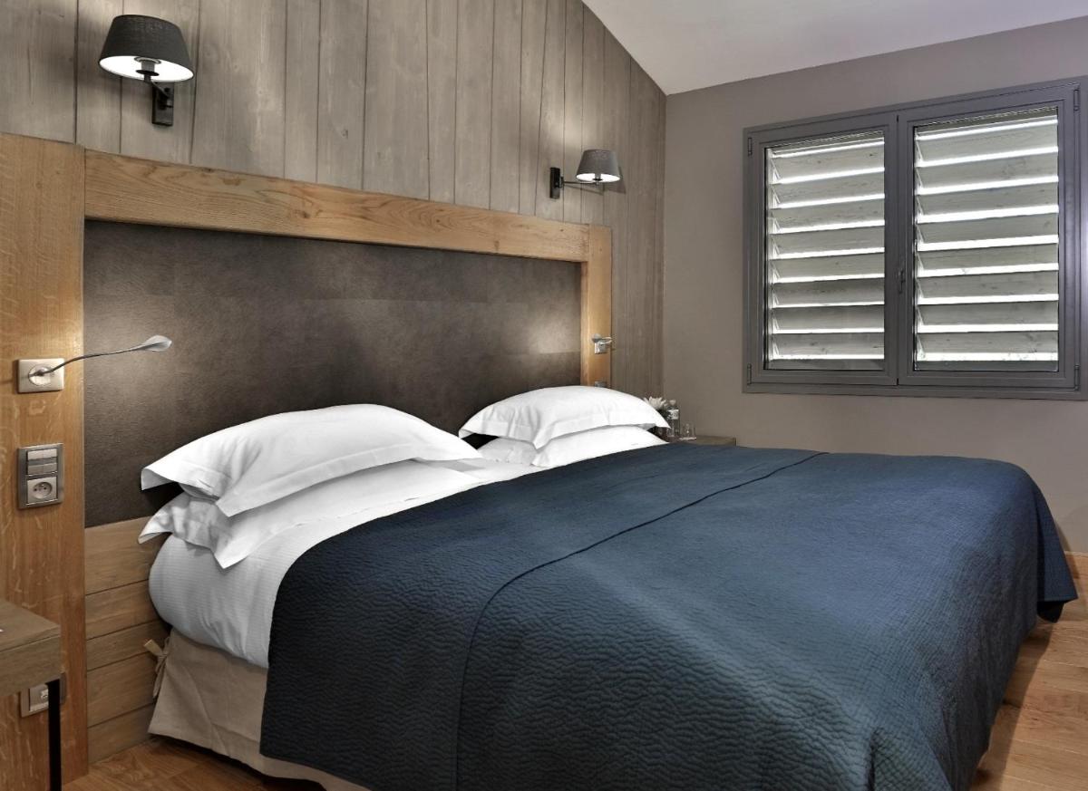 Un ou plusieurs lits dans un hébergement de l'établissement Les Glycines - Hôtel & Spa - Teritoria