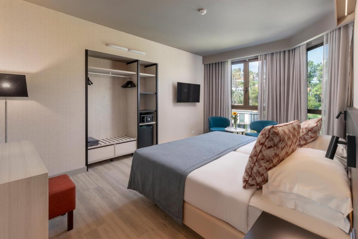 Uma cama ou camas num quarto em Enotel Magnólia