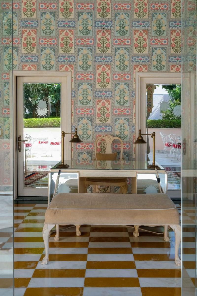 a room with a bed and two mirrors at Rajmahal Palace RAAS in Jaipur