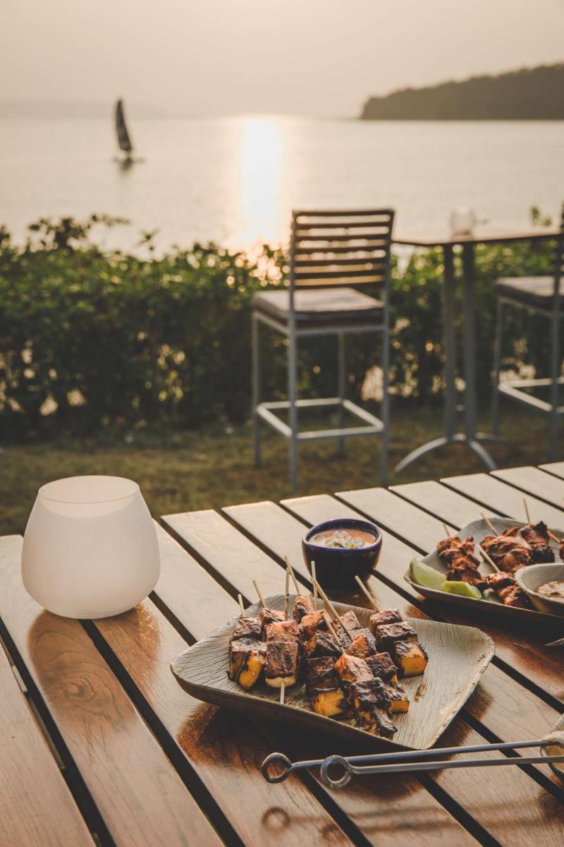 a table with a plate of food on top of it at Grand Hyatt Goa in Panaji a table with a plate of food on top of it at Grand Hyatt Goa in Panaji