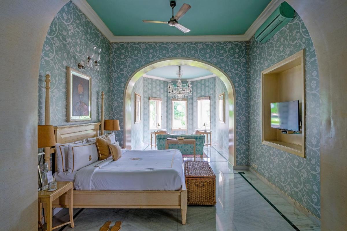 a bedroom with a bed and a tv on the wall at Rajmahal Palace RAAS in Jaipur