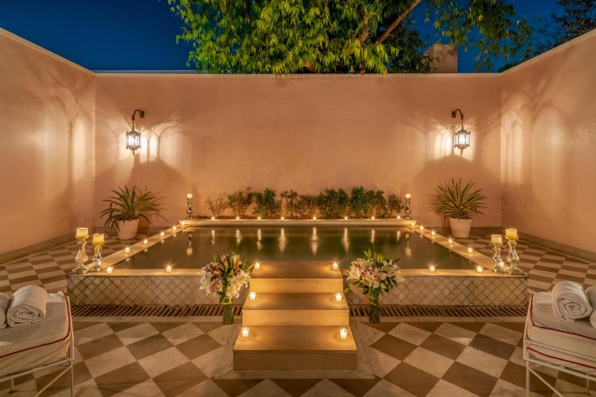 a pool with lights and plants in a building at Rajmahal Palace RAAS in Jaipur