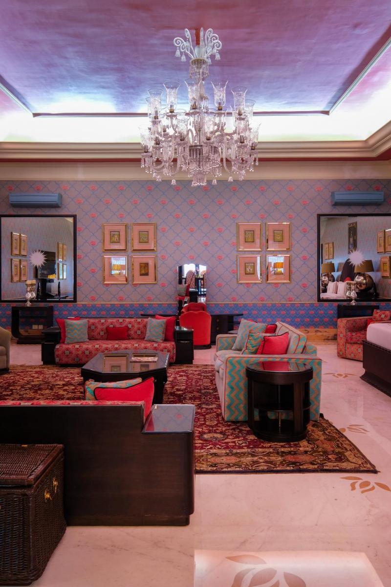 a living room with couches and a chandelier at Rajmahal Palace RAAS in Jaipur