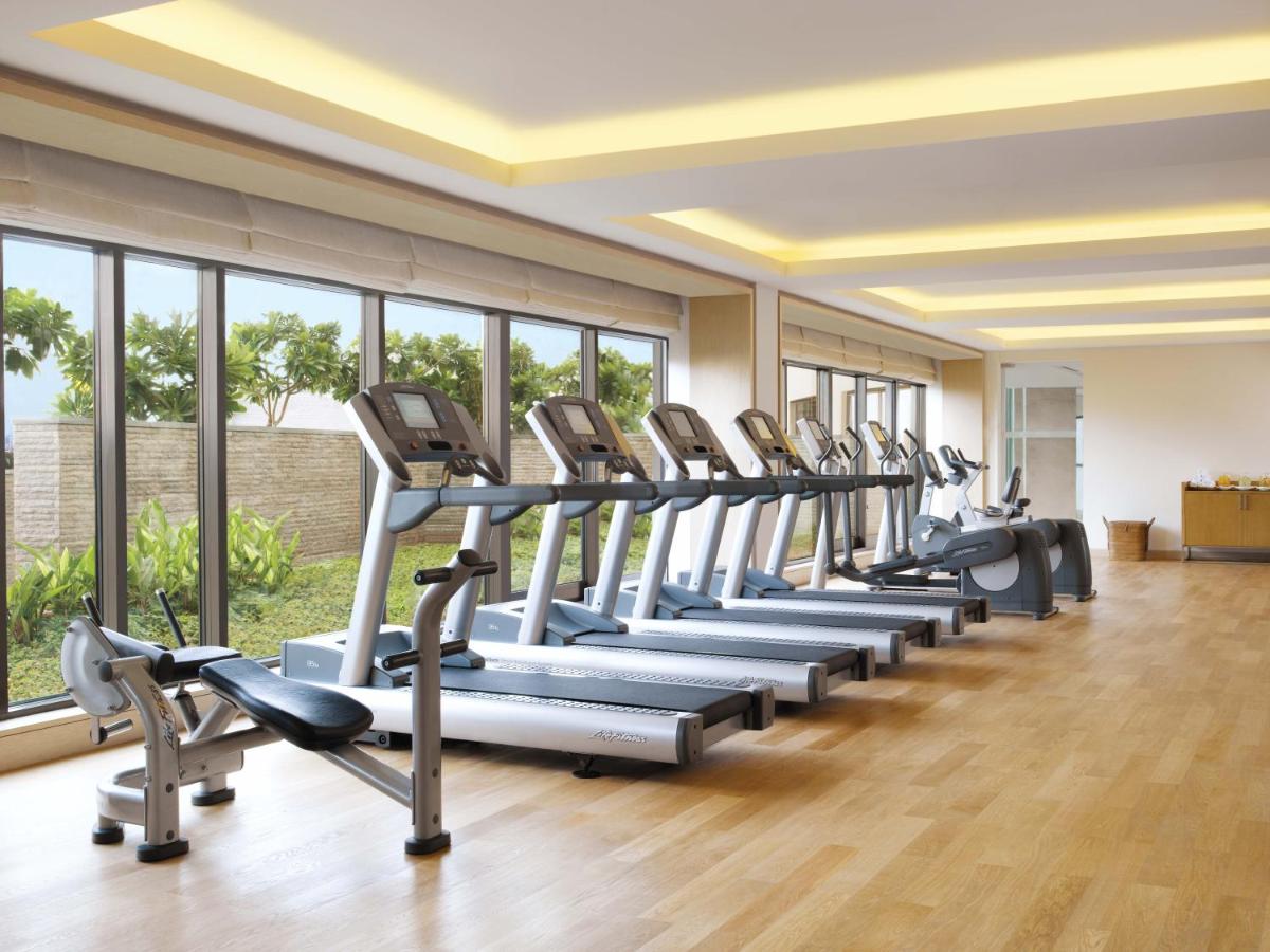 a row of treadmills in a gym with windows at Trident Bandra Kurla in Mumbai a row of treadmills in a gym with windows at Trident Bandra Kurla in Mumbai