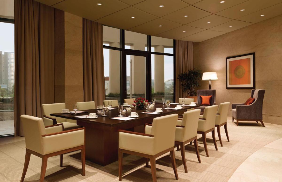 a dining room with a long table and chairs at Trident Bandra Kurla in Mumbai a dining room with a long table and chairs at Trident Bandra Kurla in Mumbai