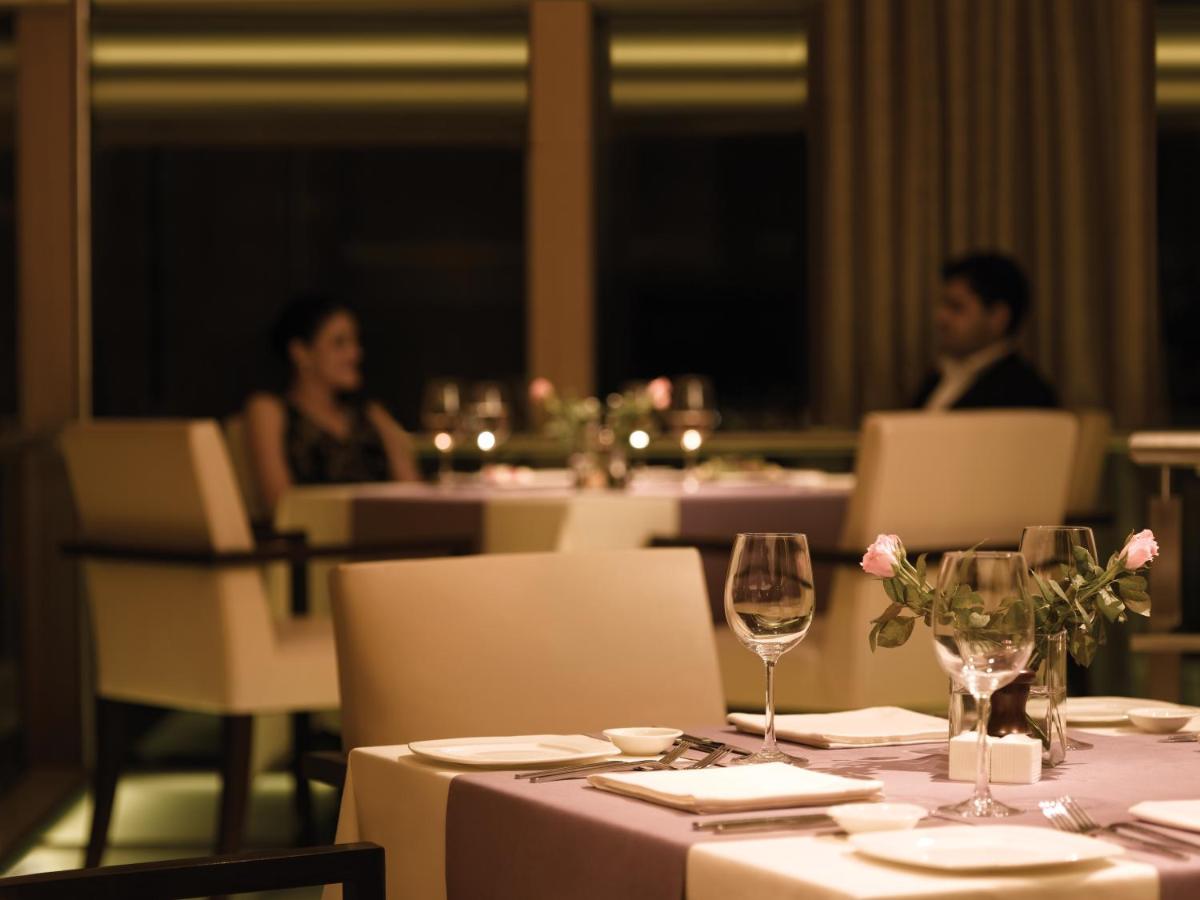 two people sitting at a table in a restaurant at Trident Bandra Kurla in Mumbai two people sitting at a table in a restaurant at Trident Bandra Kurla in Mumbai