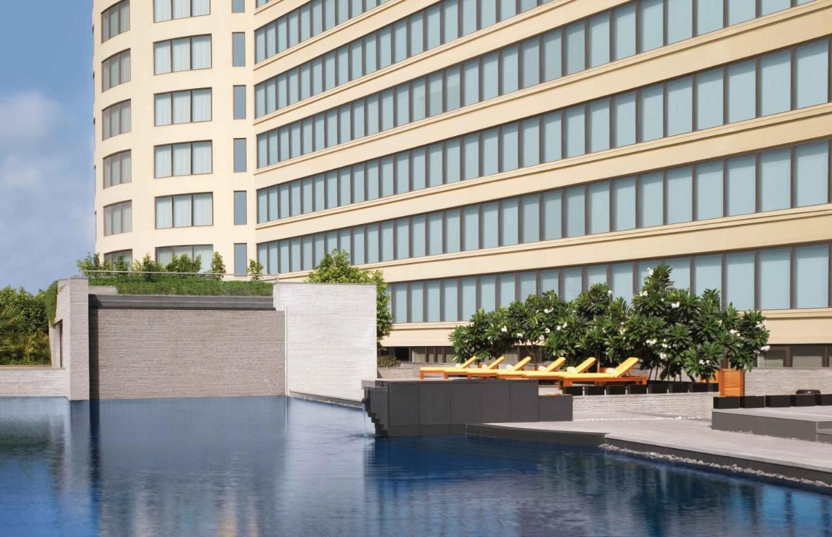 a building with a pool of water in front of it at Trident Bandra Kurla in Mumbai a building with a pool of water in front of it at Trident Bandra Kurla in Mumbai