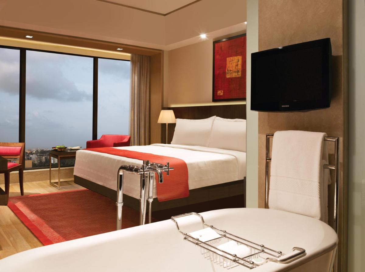 a hotel room with a bed and a bath tub at Trident Bandra Kurla in Mumbai a hotel room with a bed and a bath tub at Trident Bandra Kurla in Mumbai