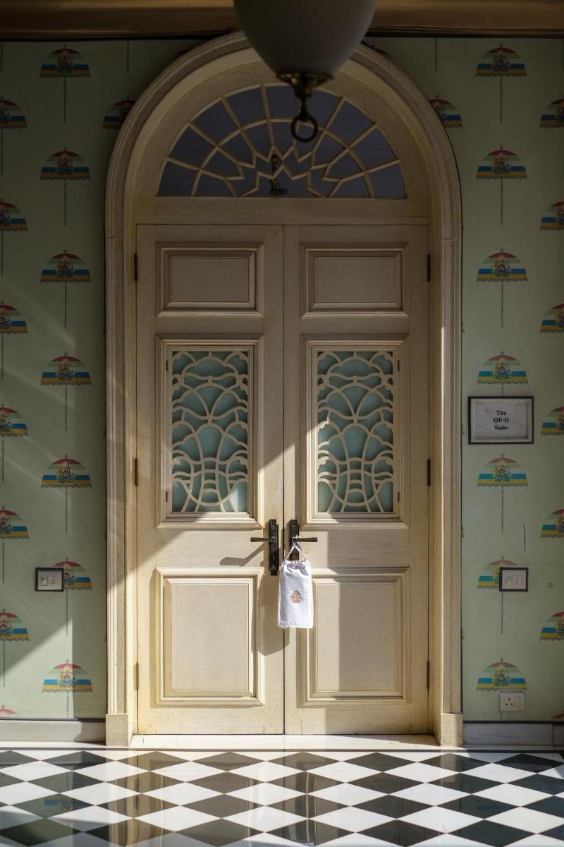 a door in a room with a checkered floor at Rajmahal Palace RAAS in Jaipur