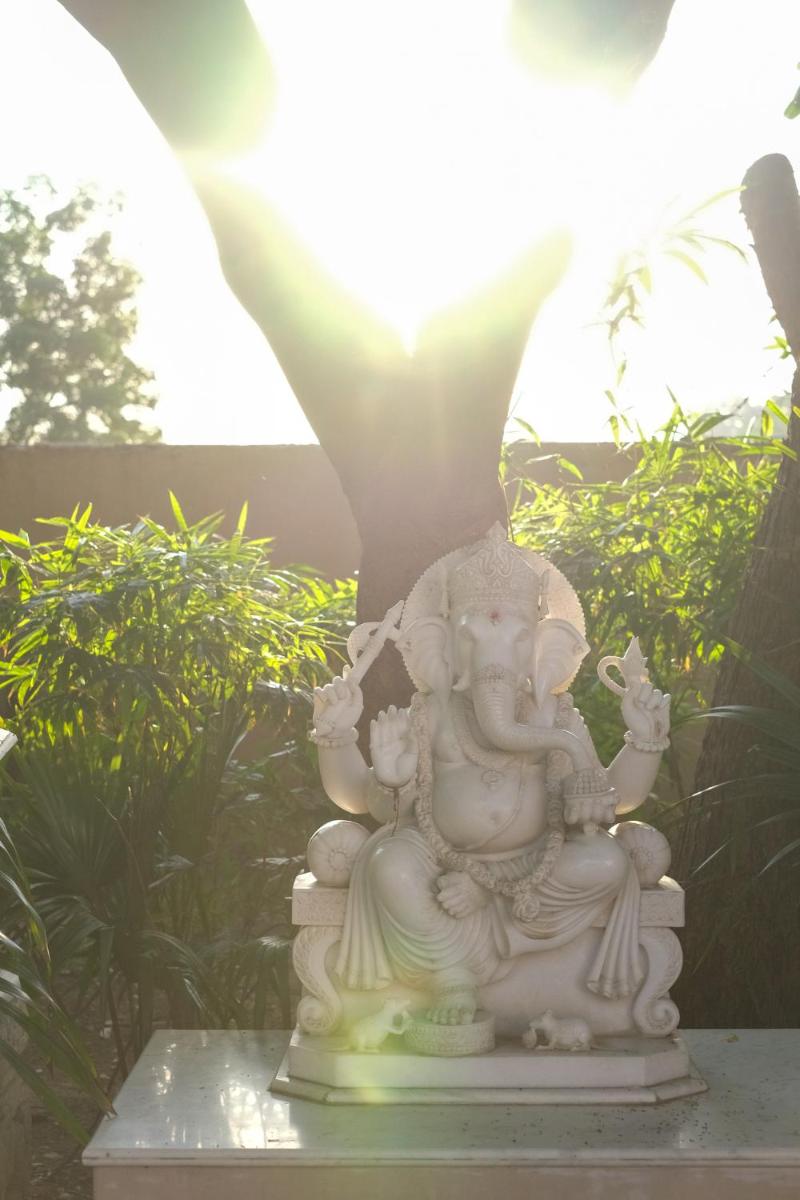 a white statue sitting on top of a table at Rajmahal Palace RAAS in Jaipur