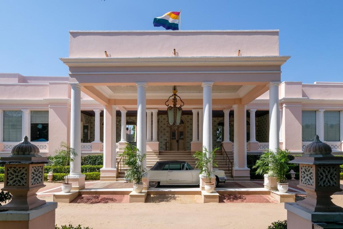a pink building with a car in front of it at Rajmahal Palace RAAS in Jaipur