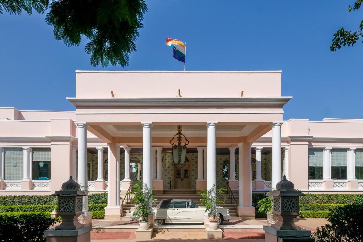 a white house with a car in front of it at Rajmahal Palace RAAS in Jaipur