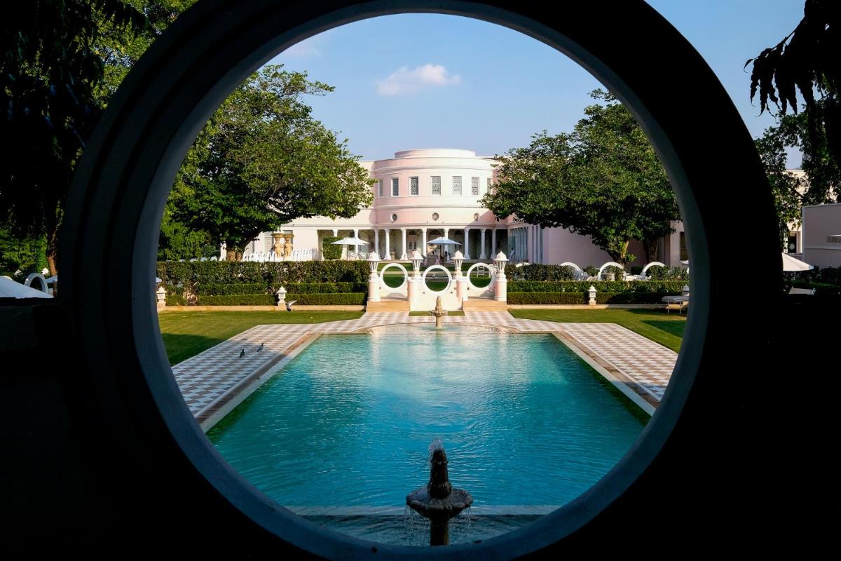 a view of a pool in front of a white house at Rajmahal Palace RAAS in Jaipur