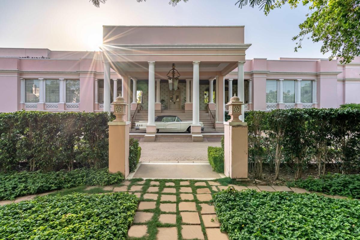 an exterior view of a pink mansion at Rajmahal Palace RAAS in Jaipur