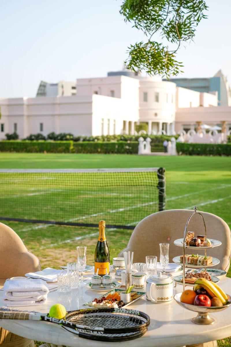 a table with food and drinks on a tennis court at Rajmahal Palace RAAS in Jaipur