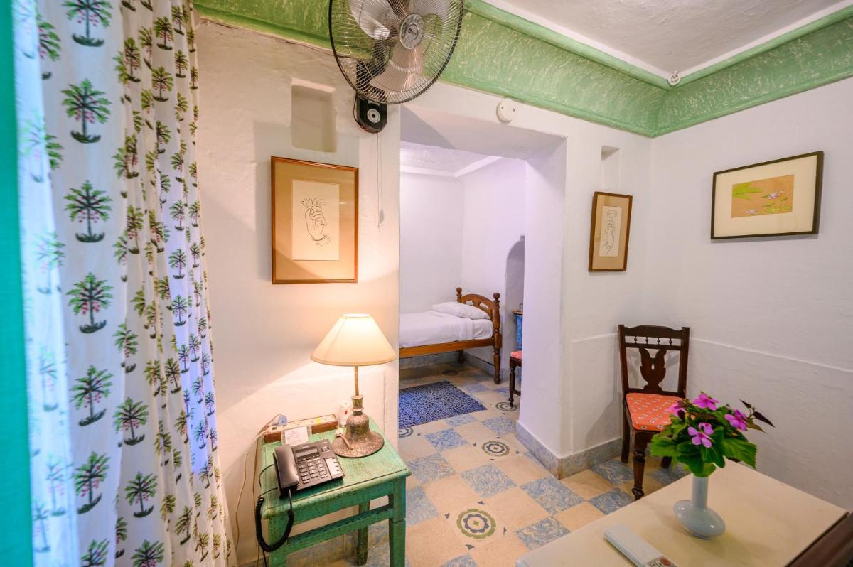 a room with a desk and a phone on a table at Neemrana Fort-Palace in Neemrana