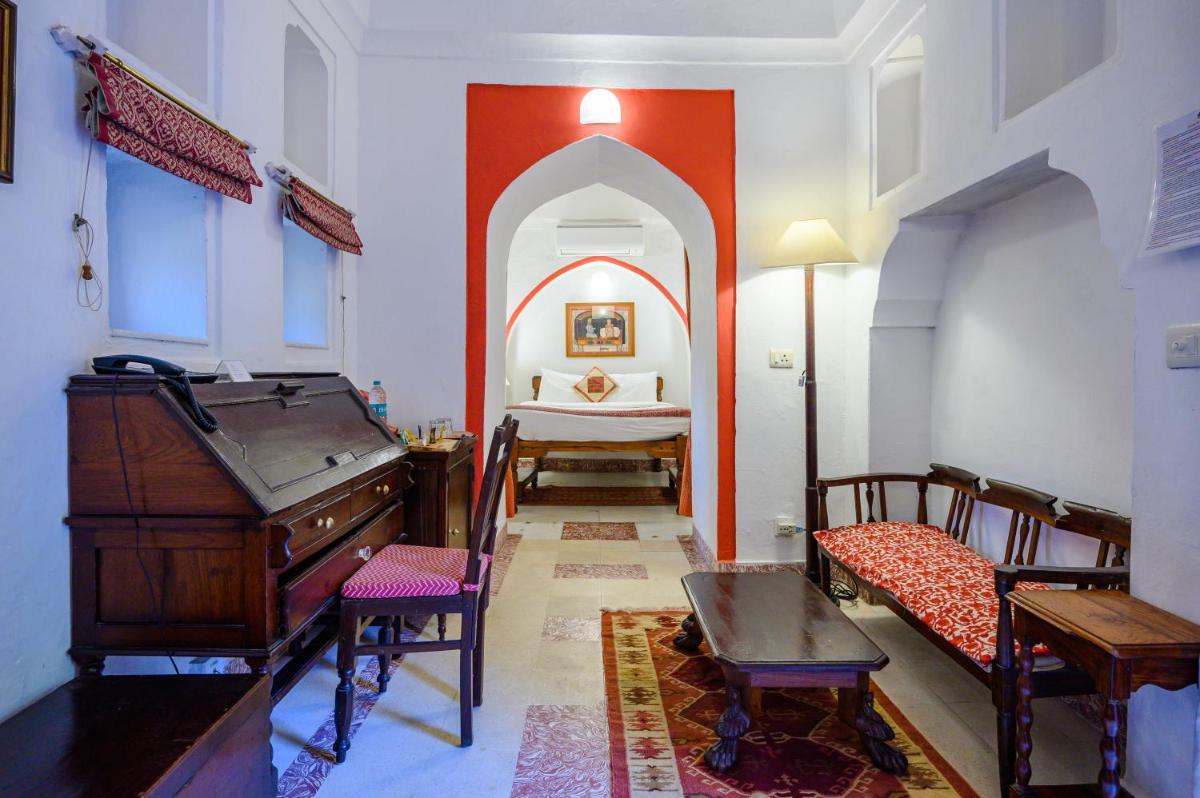a room with a piano and a bed in it at Neemrana Fort-Palace in Neemrana