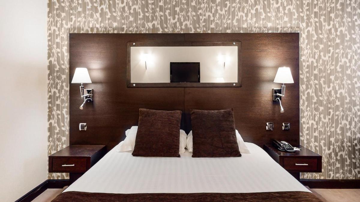 Un ou plusieurs lits dans un hébergement de l'établissement Hotel Palladia