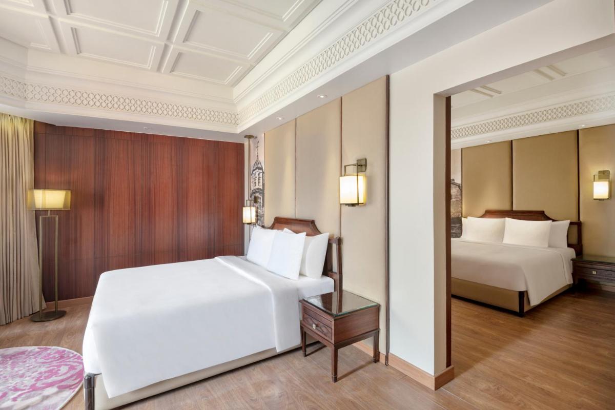 a hotel room with two beds and a table at Radisson Kufri in Shimla