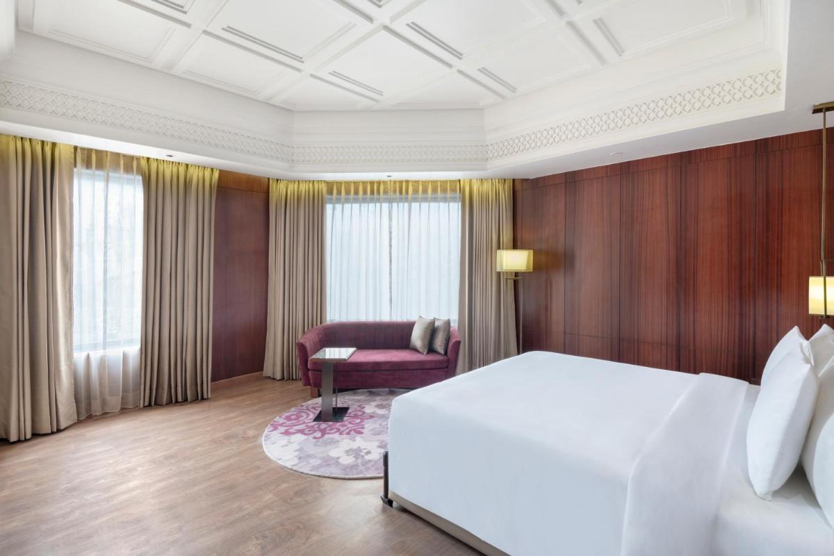 a hotel room with a bed and a chair at Radisson Kufri in Shimla