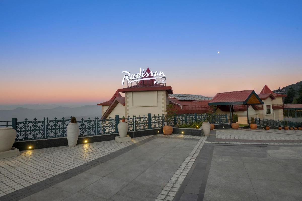 a building with a sign on top of it at Radisson Kufri in Shimla
