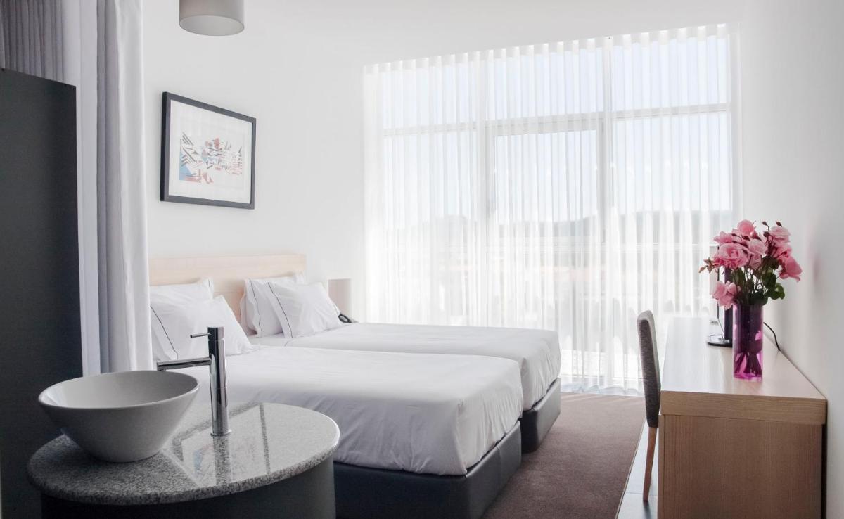 Uma cama ou camas num quarto em Boticas Hotel Art & SPA