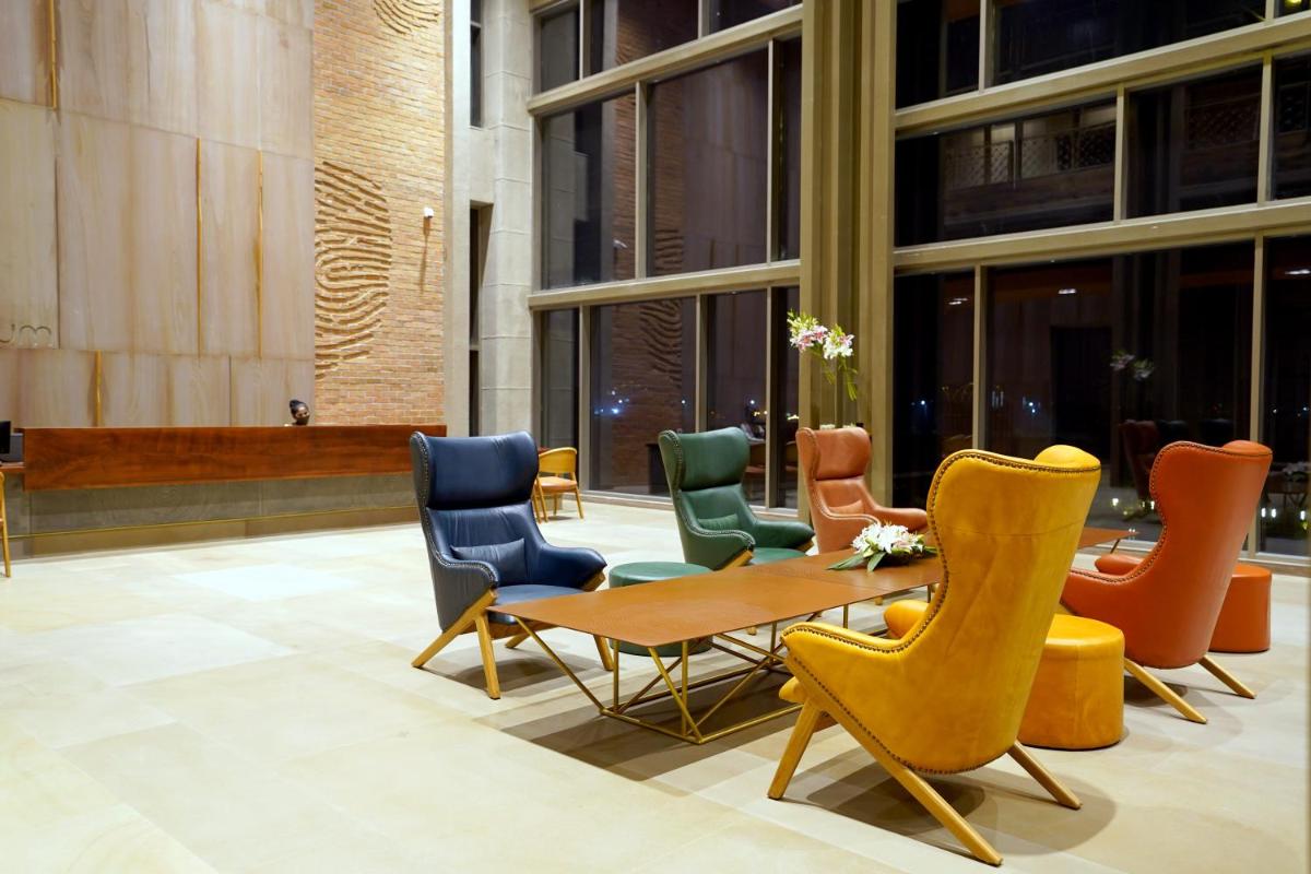 a group of chairs and a table in a lobby at The Centrum in Lucknow