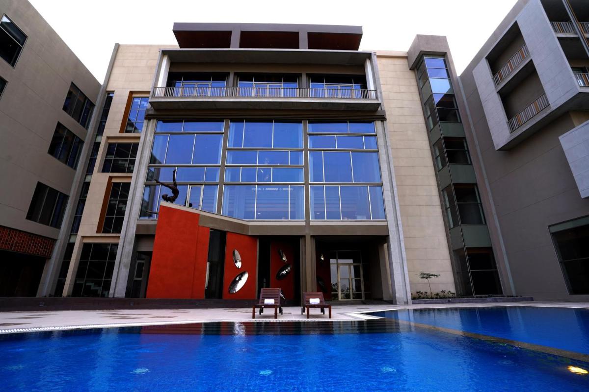 a building with a swimming pool in front of it at The Centrum in Lucknow