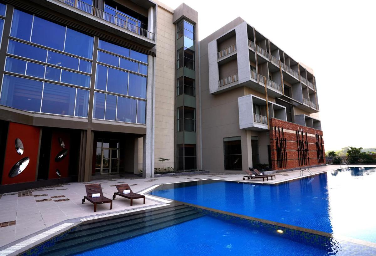 a building with a swimming pool in front of a building at The Centrum in Lucknow