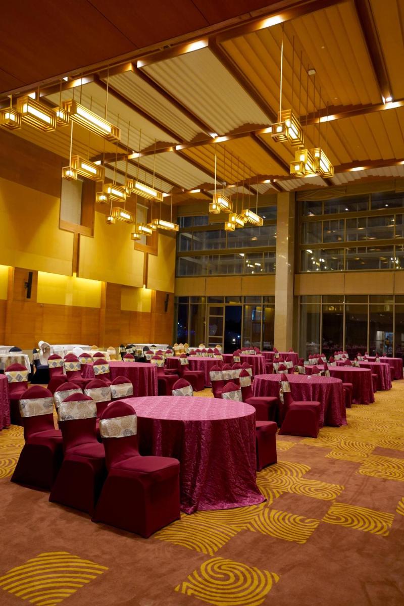a large banquet hall with purple tables and chairs at The Centrum in Lucknow +45 photos