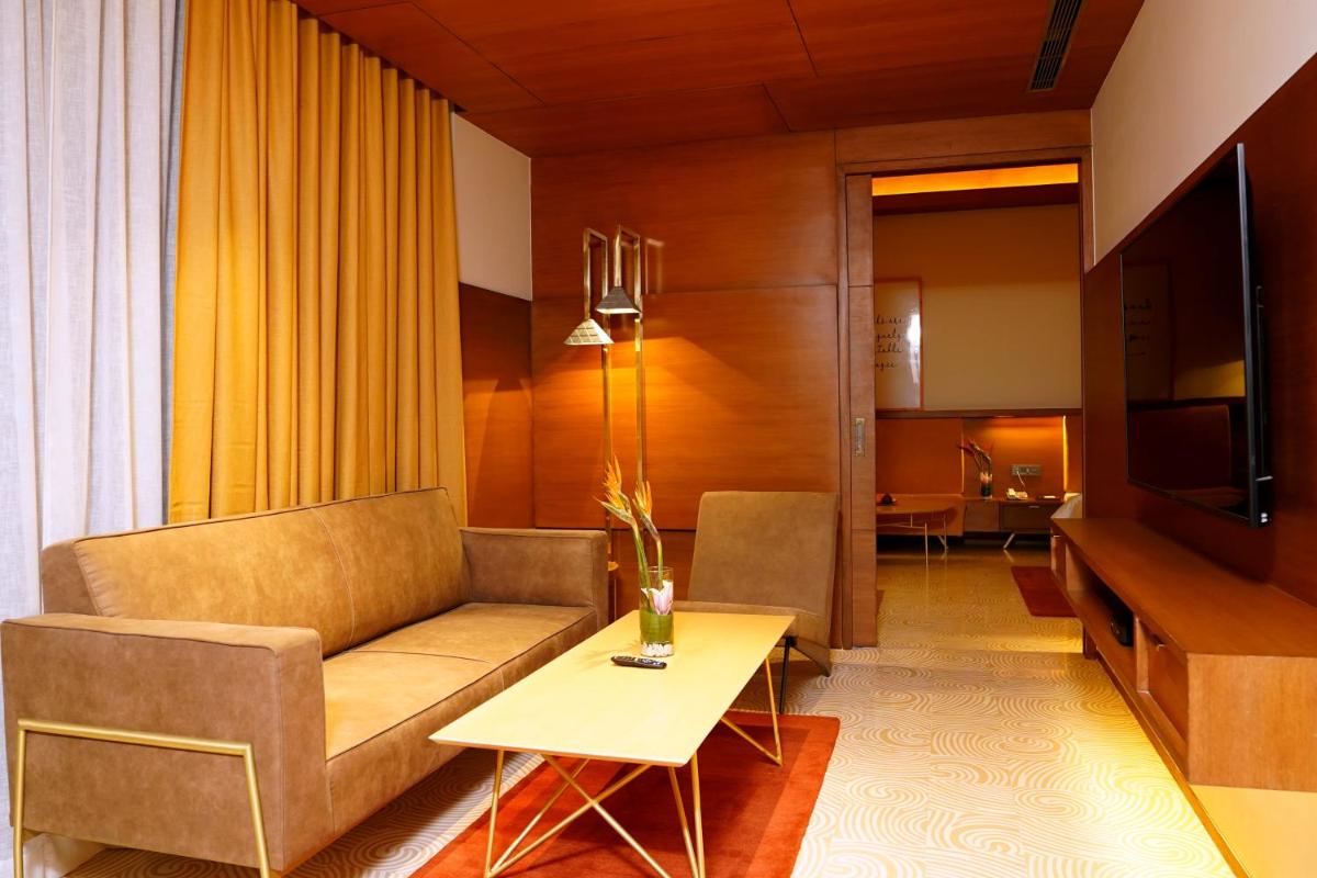 a living room with a couch and a table at The Centrum in Lucknow