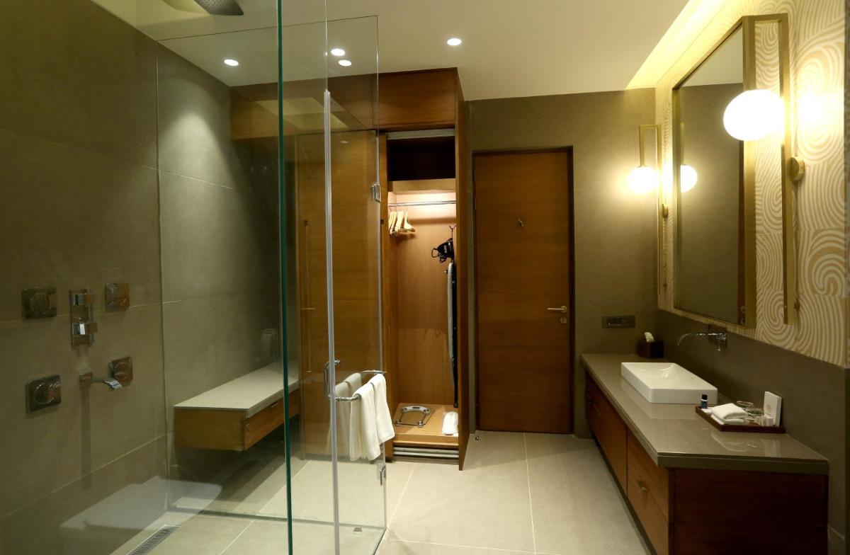 a bathroom with a shower and a sink at The Centrum in Lucknow