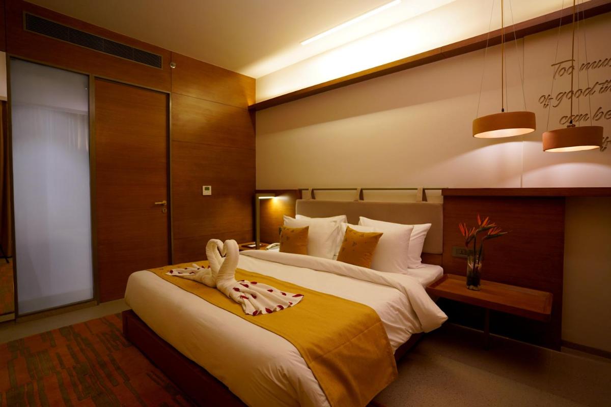 a hotel room with a bed with a towel on it at The Centrum in Lucknow