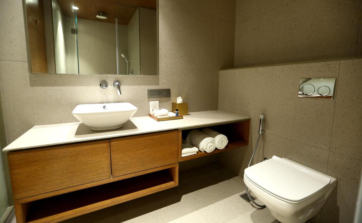 a bathroom with a sink and a toilet at The Centrum in Lucknow