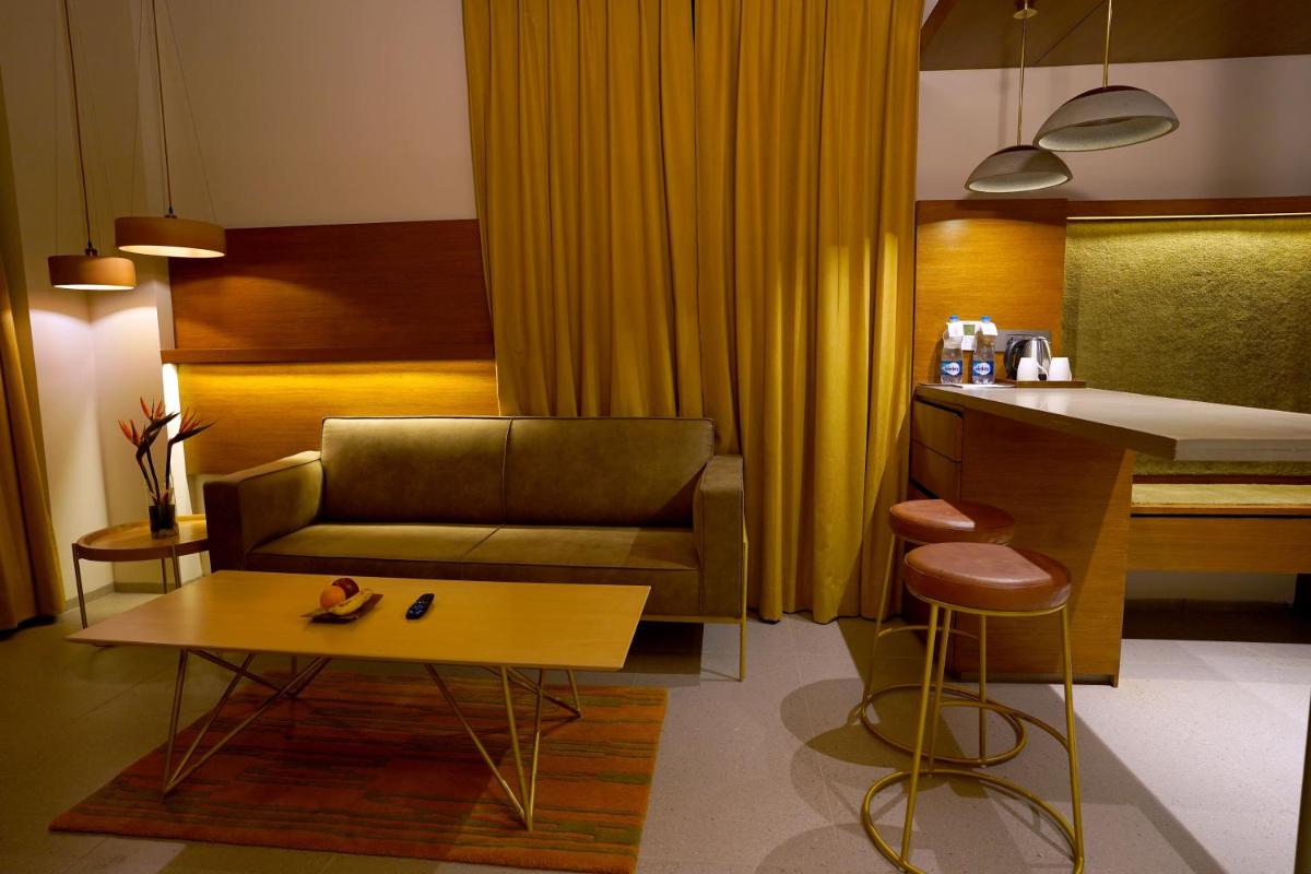 a living room with a couch and a table at The Centrum in Lucknow