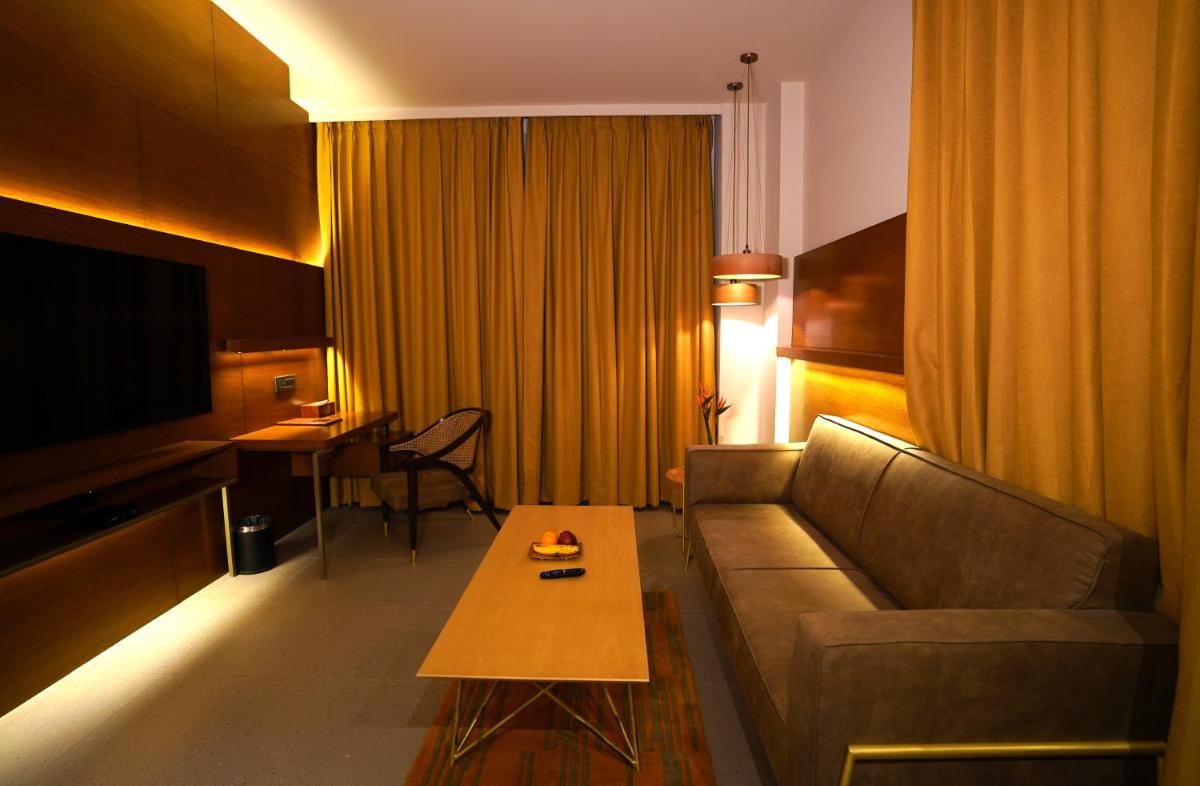 a living room with a couch and a table at The Centrum in Lucknow
