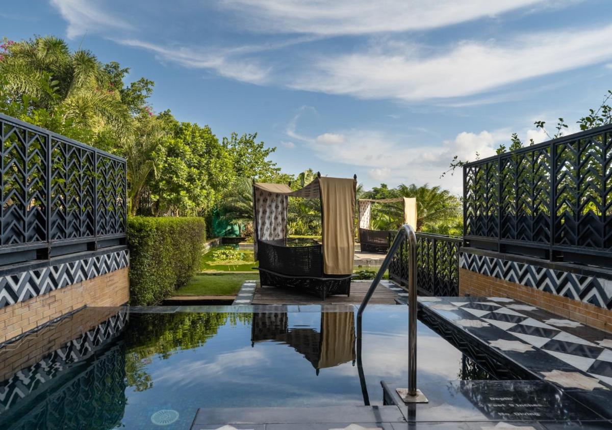 a swimming pool in a yard with a fence at The Leela Palace Udaipur in Udaipur